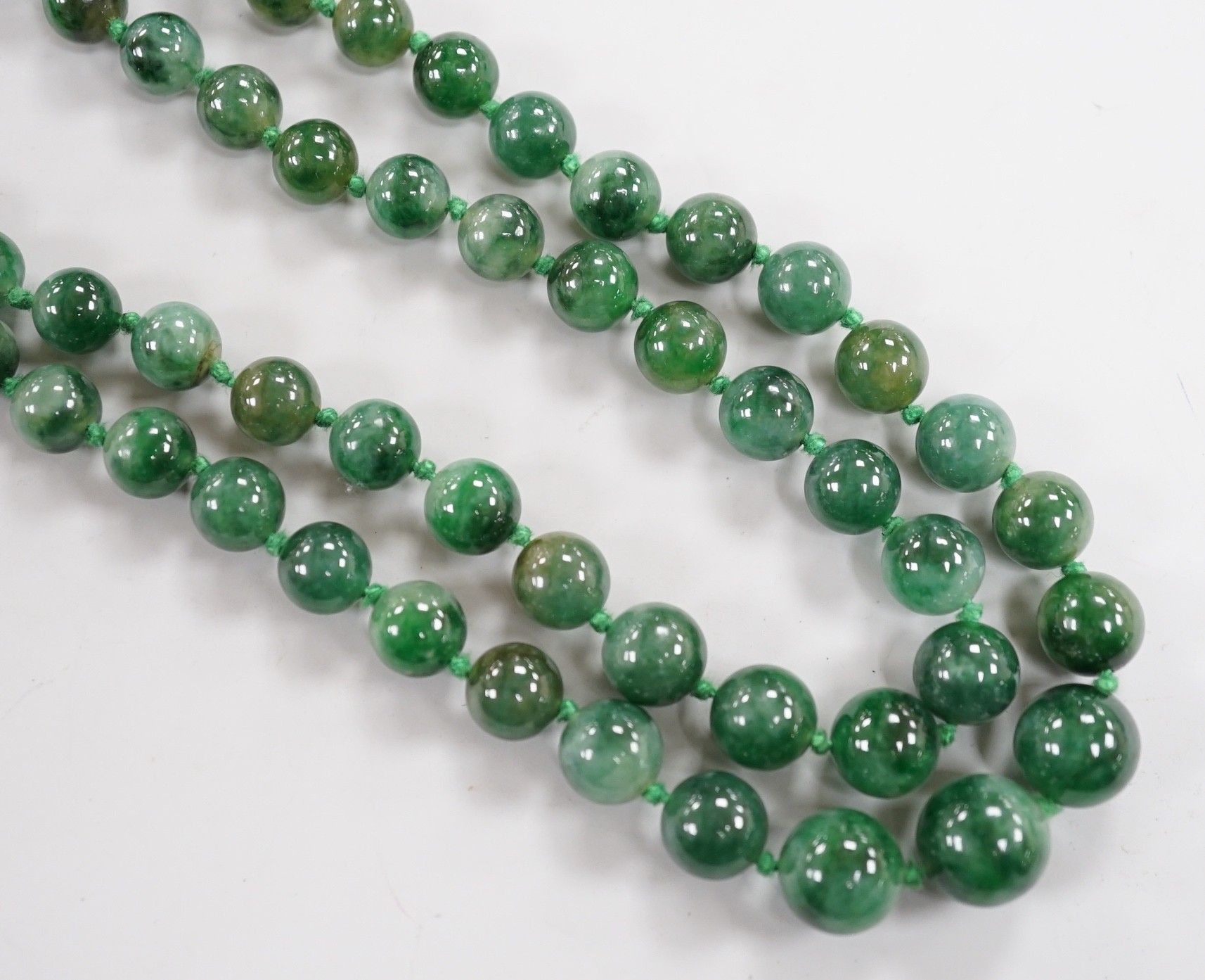 A double strand jade bead necklace, with carved jade and white metal clasp, 45cm, gross weight 101 grams.